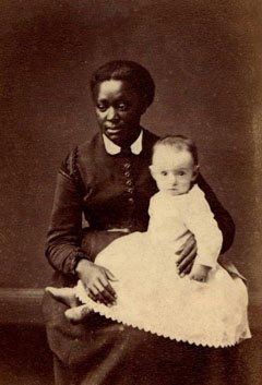 Historic photo of an anonymous black nanny and the white child in her care.